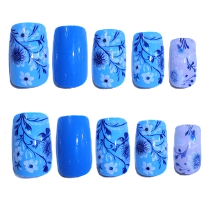 Detailed view of blue floral press-on nails with hand-painted vine patterns and glossy finish