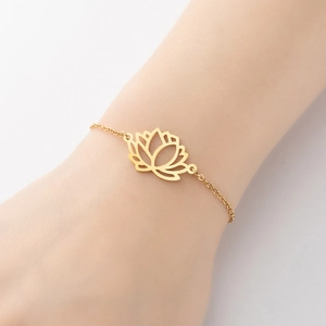 Golden lotus pendant bracelet on model wrist with elegant cutout floral details