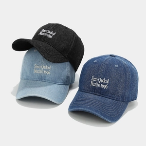 Three colors of denim baseball caps with contrast stitching and letter embroidery