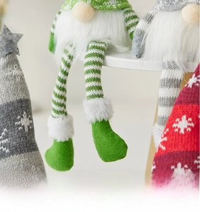 Detail of Christmas gnome plush with striped legs and long faux fur beard decoration
