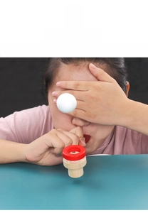 Detail of wooden breath training toy with floating foam ball and red ring holder