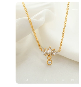 Close-up of crown-shaped gold necklace pendant with marquise and round zircon stones