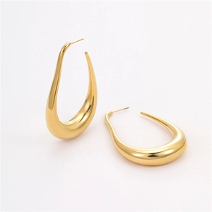 Macro shot of polished gold-finished stainless steel hollow U-shaped hoop earrings