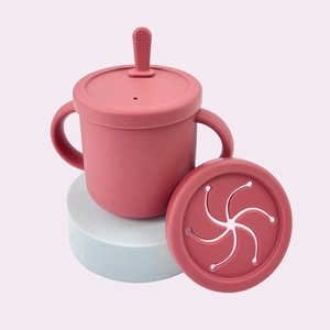 Pink silicone baby training cup with dual handles, straw lid and petal snack lid