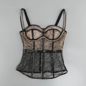 Detailed view of black sequin mesh corset dress with bone structure and nude lining