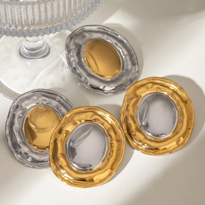 Polished 18k gold and silver stainless steel hoop earrings with lava texture