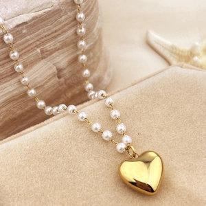 Elegant 18K gold plated heart pendant necklace with pearls on a luxury velvet display