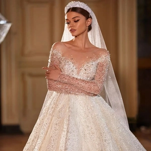 Close-up of luxury ivory wedding gown with hand-sewn sequins and beaded embroidery