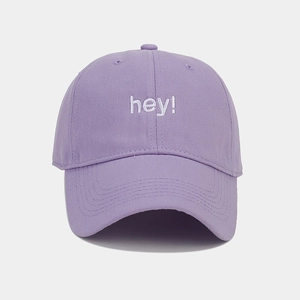 Detail of white hey embroidery on a light purple soft top cotton baseball cap