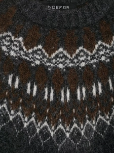 Close-up of Nordic geometric jacquard pattern on a thick retro knit sweater texture