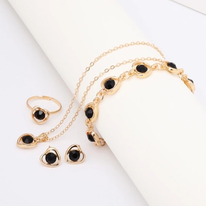 Golden jewelry set with black crystal heart necklace, bracelet, earrings and open ring