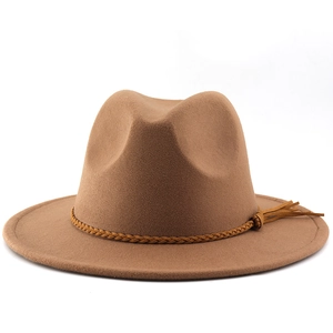 Close-up of camel wide brim cowboy hat with woven leather band and fringe tassel detail