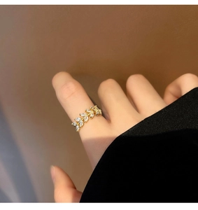 Detailed view of olive leaf ring with marquise-cut cubic zirconia in gold finish