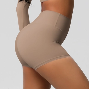 Detail shot of high-waisted yoga shorts showing tummy control and butt-lifting texture