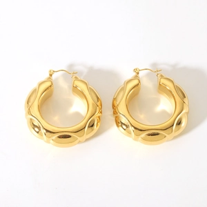 Close-up of hollow twisted hoop earrings with 18K gold plating and wavy texture