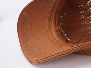 Macro shot of dark khaki cotton baseball cap brim with precise reinforced stitching