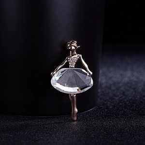 Macro shot of rose gold ballet dancer brooch featuring sparkling crystal and pavé rhinestones