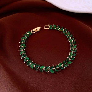Detail of gold-plated leaf bracelet with marquise-cut green zircon and fold-over clasp