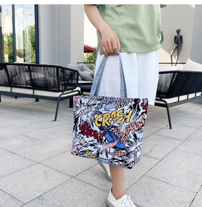 Detail of canvas tote bag with colorful comic print showing high capacity and soft texture