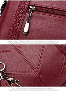 Detail of wine red pebbled leather bag with cat charm and intricate diamond stitching