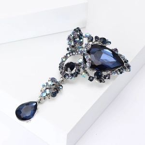 Macro shot of vintage silver-tone brooch with dark blue waterdrop stones and rhinestones