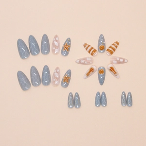 Detailed view of ocean-themed press-on nails with 3D starfish, shells, and pearls