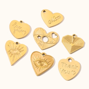 Set of seven golden stainless steel heart pendants with engraved text and evil eye patterns