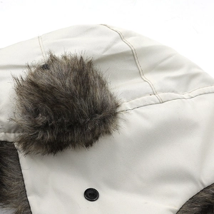 Winter trapper hat in beige canvas with brown faux fur trim and snap button detail