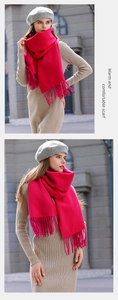 Detailed close-up of rose red cashmere-feel scarf texture and elegant fringe tassels