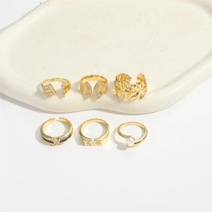 Detail view of 6-piece vintage gold ring set featuring pearls and geometric designs