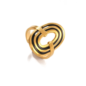 Abstract geometric star ring in gold finish with black enamel layers and an open design