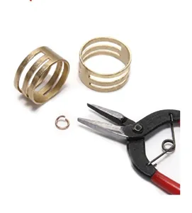 Close-up of jewelry making pliers and brass jump ring opener tool for DIY crafts