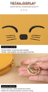 Detail of yellow lychee leather mini bag with black cat embroidery and gold clasp