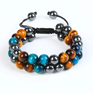 Detail of double-layer tiger eye and hematite beaded bracelet with adjustable woven knot