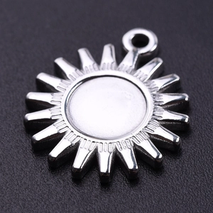 Macro shot of sun-shaped 304 stainless steel pendant with central groove for DIY jewelry