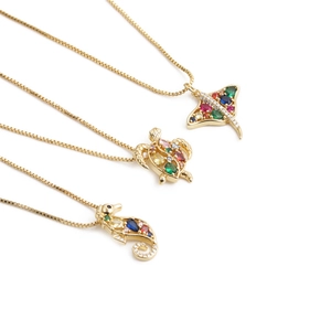 Gold necklaces featuring seahorse, turtle and ray pendants with colorful zircon inlay