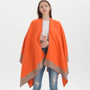 Detail of orange shawl with brown striped edges showing soft drape and wrap fit