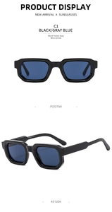 Detail view of vintage square sunglasses with thick black frames and gray blue lenses