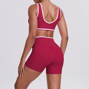 Rear view of two-piece dark red yoga set featuring white contrast trim and U-neck bra
