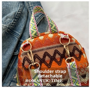 Detail of ethnic embroidery backpack with detachable colorful straps and gold hardware