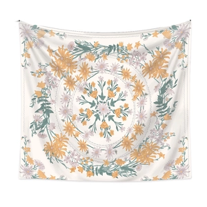 Detail of bohemian mandala tapestry featuring orange floral patterns and green leaves