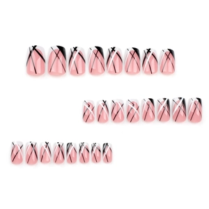 Short square press-on nails with nude pink base and black-white geometric diagonal lines