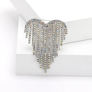 Detailed close-up of a silver heart brooch featuring sparkling rhinestone tassel fringe