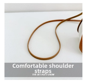 Detail view of the brown leather adjustable shoulder strap for kids cartoon bag