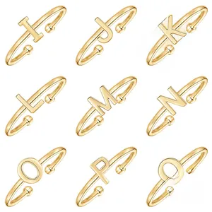 Detail view of gold S925 sterling silver adjustable rings with letters I through Q