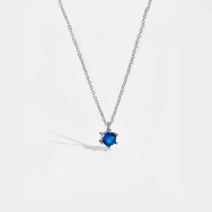 Detailed view of the S925 silver necklace featuring a sparkling round blue zircon pendant
