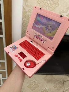 Pink toy laptop with mouse showing learning icons and standard keyboard layout for kids