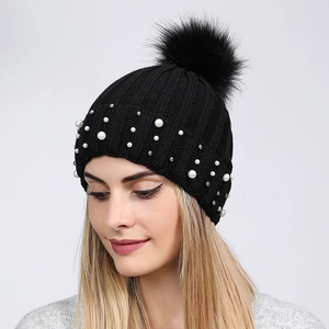 Women's black knit beanie with pearls, silver studs and a large faux fur pompom ball