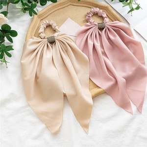 Detail of silk satin scrunchies with long streamers and rhinestone metal rings