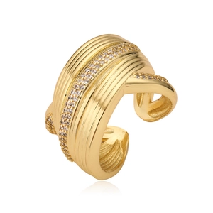 Detail of gold-plated copper ring featuring micro-pave zircons and wave texture